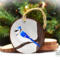 Blue jay perched on a limb hand-painted wood slice Christmas ornament at Cove Creek Photography